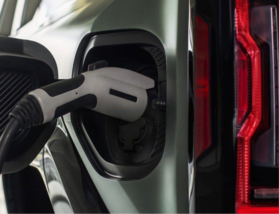 Close up of charging port with charger plugged in on a GMC Hummer EV SUV - Port Lavaca GMC in PORT LAVACA TX